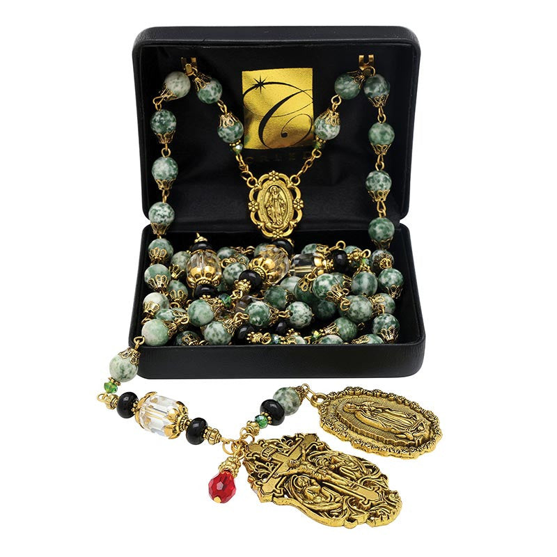 Gold and green bead rosary necklace with decorative pendants in a black gift box.