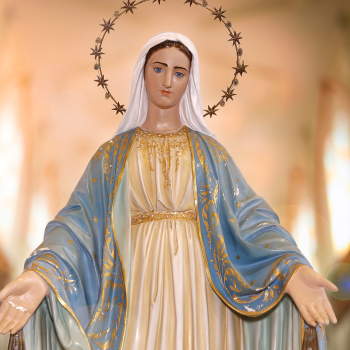 Statue of the Blessed Virgin Mary with open arms in a church