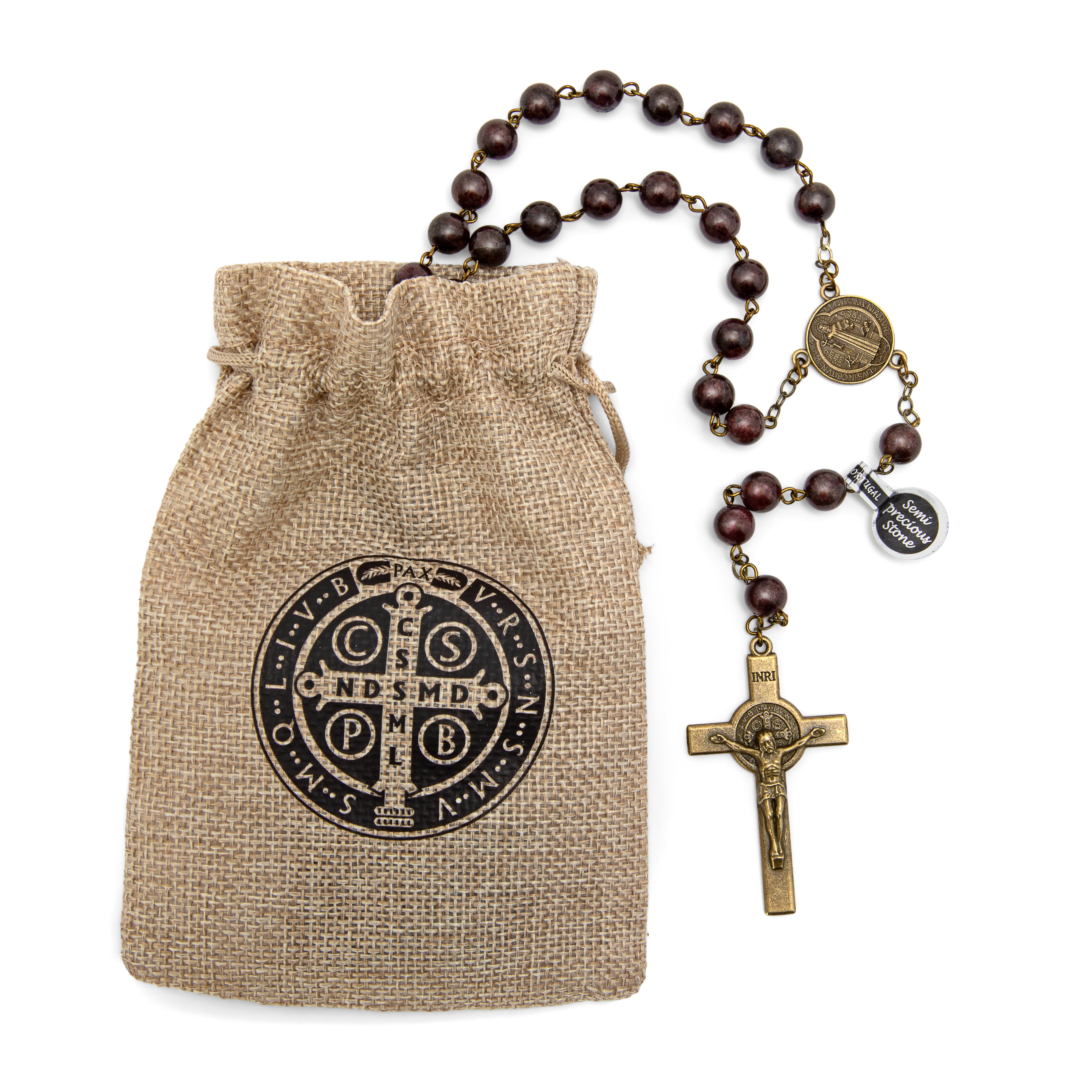 Rosary with brown beads and a gold cross on a burlap bag with a logo.