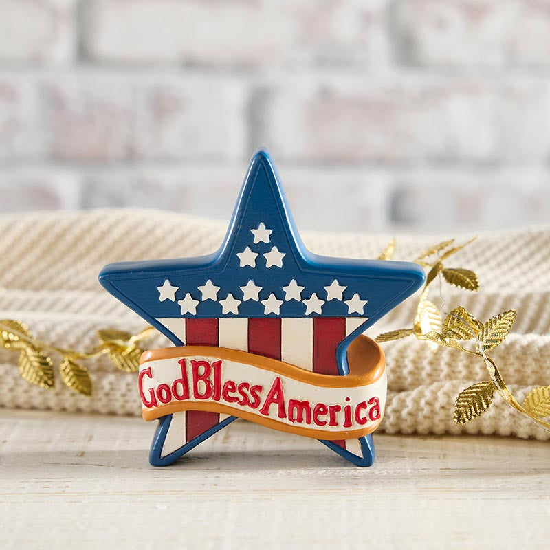 Decorative star with 'God Bless America' text on a wooden surface with a blurred background